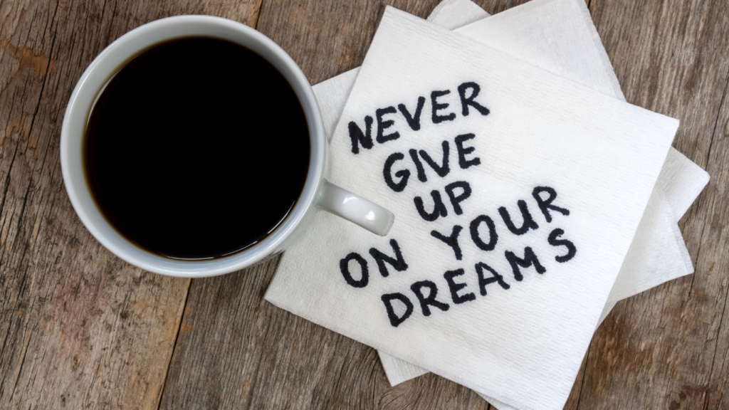 words beside a cup of coffee that say never give up on your dreams