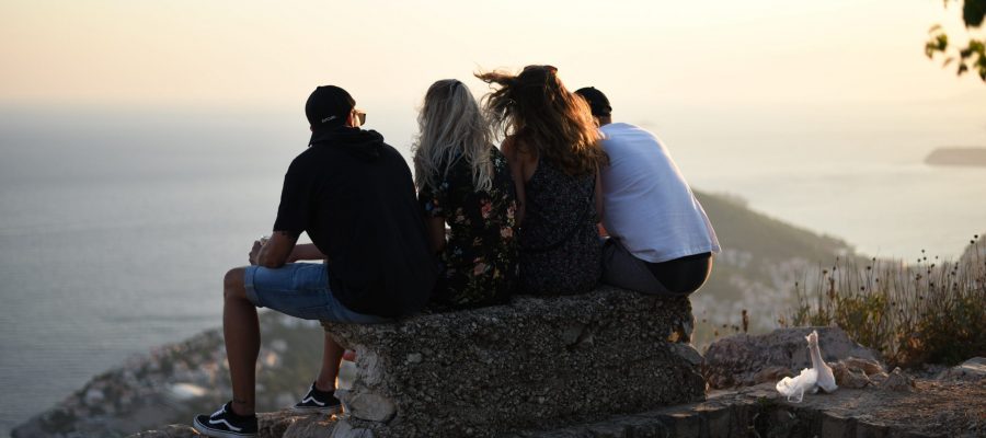 men-and-women-sitting-on-concrete-bench-1685371