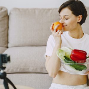 woman sitting on couch with fruits